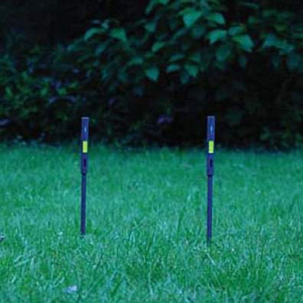 Two Firefly Arc of Fire Markers MK.II illuminated in grass during low-light conditions