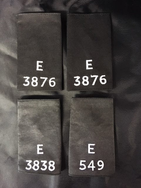 Police Surplus Police Uniform 11cm Epaulette Slides, black with silver embroidered letter E and mixed numbers, 11cm length (Used – Grade A)