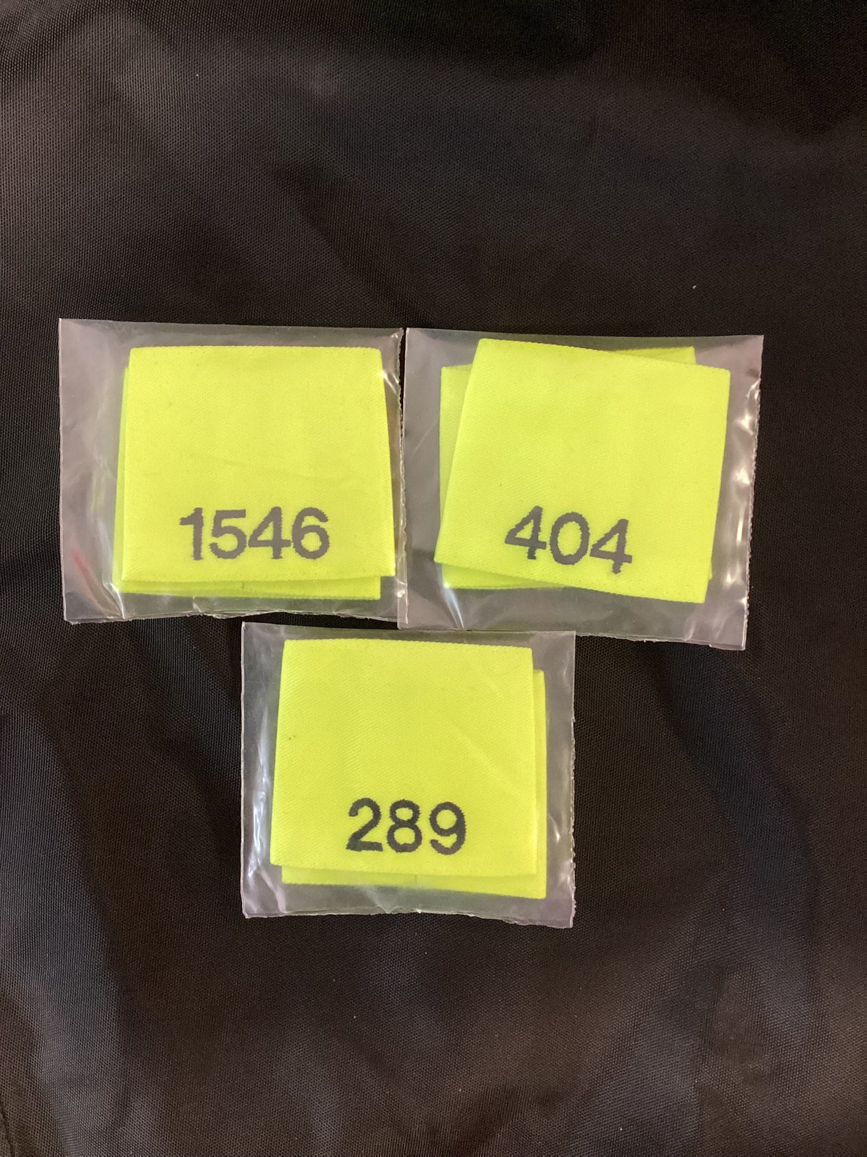 Police Surplus Police Uniform Epaulette Slides, Hi Vis yellow, black embroidered mixed numbers and lengths (Used – Grade A)