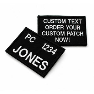 Custom embroidered black name tag with white stitched lettering