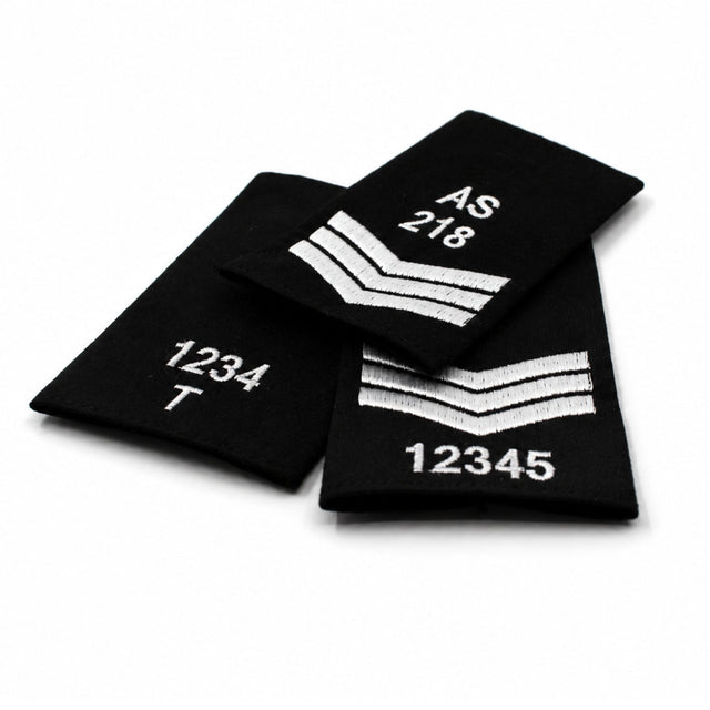 Custom embroidered black rank slide with white stitched numbers and rank markings